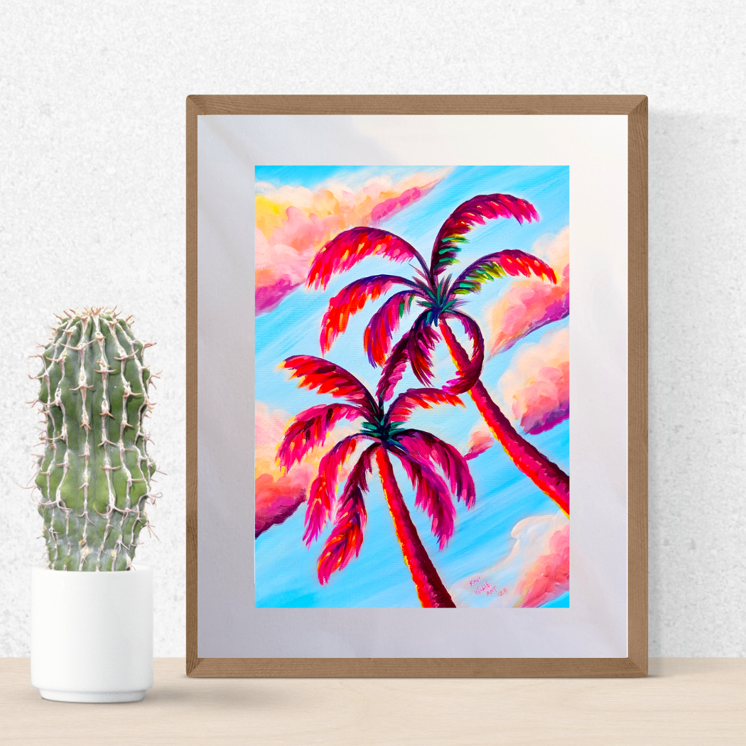 Colorful Palm Tree is a vibrant art print featuring colorful palm trees set against a bright blue sky and soft pink clouds